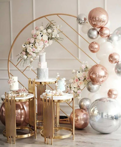 Table round stand (gold plinth) beside Backdrop